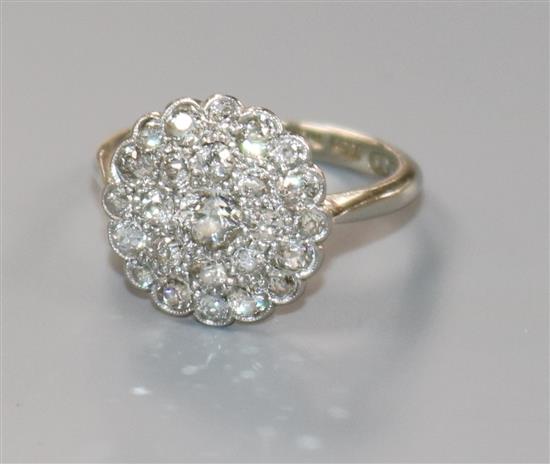 A mid 20th century 18ct white gold, platinum and diamond circular cluster ring, size L.
